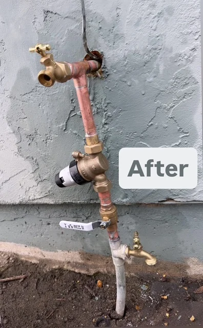 New brass outdoor faucet installed on stucco wall — completed replacement