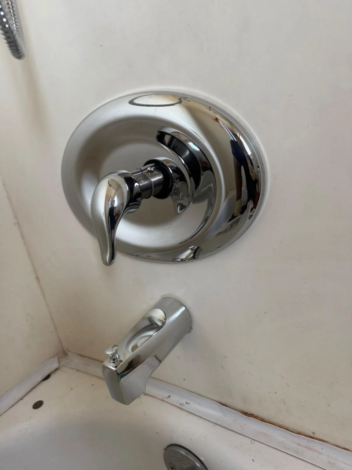 Chrome shower valve with lever handle and tub spout installed on tile wall by Economy Plumbing SD