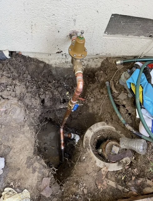 Copper water main valve installation with brass shutoff valve and underground piping connections